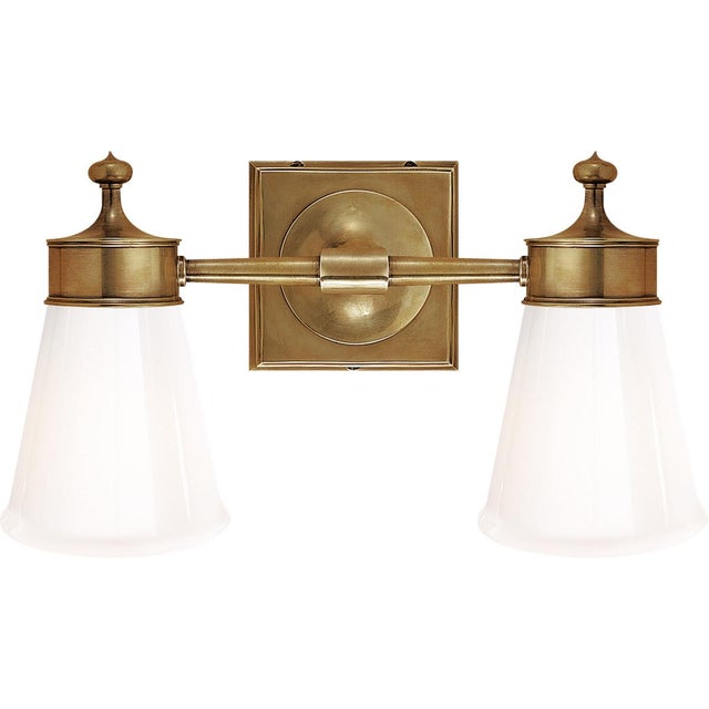 Siena Double Sconce in Hand-Rubbed Antique Brass with White Glass Height: 8.25" Extension: 6" Backplate: 4.75" Square...
