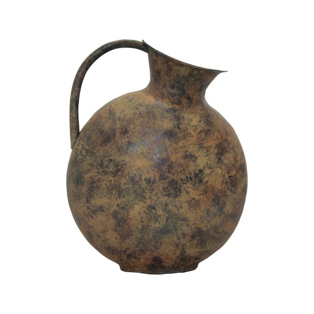 This metal vase features a sculptural silhouette and a weathered bronze finish that adds warmth and character. Its unique...