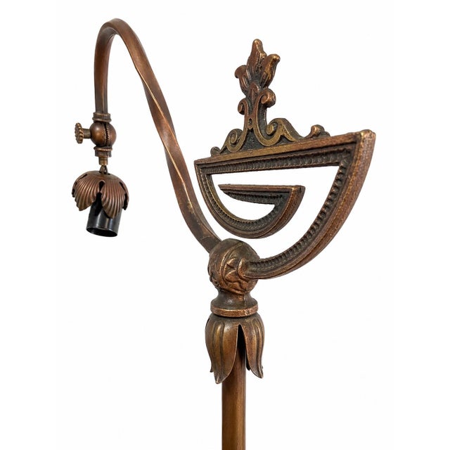 Antique American bridge floor lamp with a sculptural cast iron base and distinctive period details. An eye-catching...