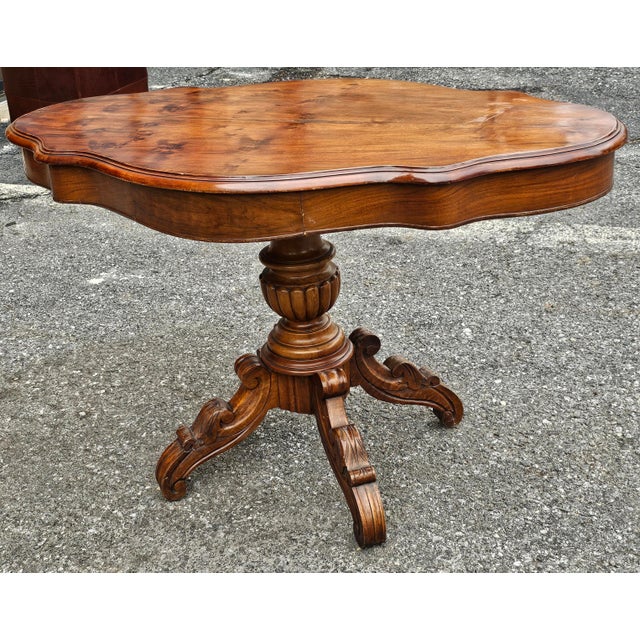 A 19th Century Victorian Renaissance Style Walnut Two-Drawer Pedestal Center Table. Measures 45" in width, 26" in depth...