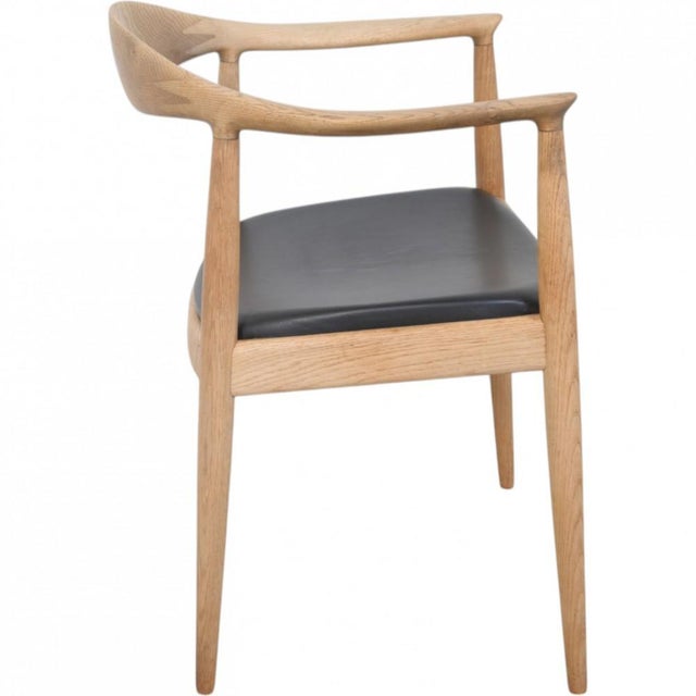 Hans Wegner The Chair, model JH503, with a frame of oak and a seat upholstered in black leather. The chair is from the...