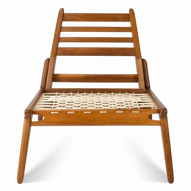 Wooden armchair by the East German furniture manufacturer VEB möbelwerk Naumburg. The low, relaxing armchair has a solid...