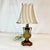 This is an attractive Urn Style Petite table lamp. It features a Neoclassical style urn body with two side handles. The...