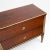 Neoclassical chest of drawers with two drawers and brass profiles. The pilaster strips are fluted and also accentuated in...