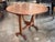 19th century French oak wine table with a round plank top that tilts upright to store flat against a wall. The top has...