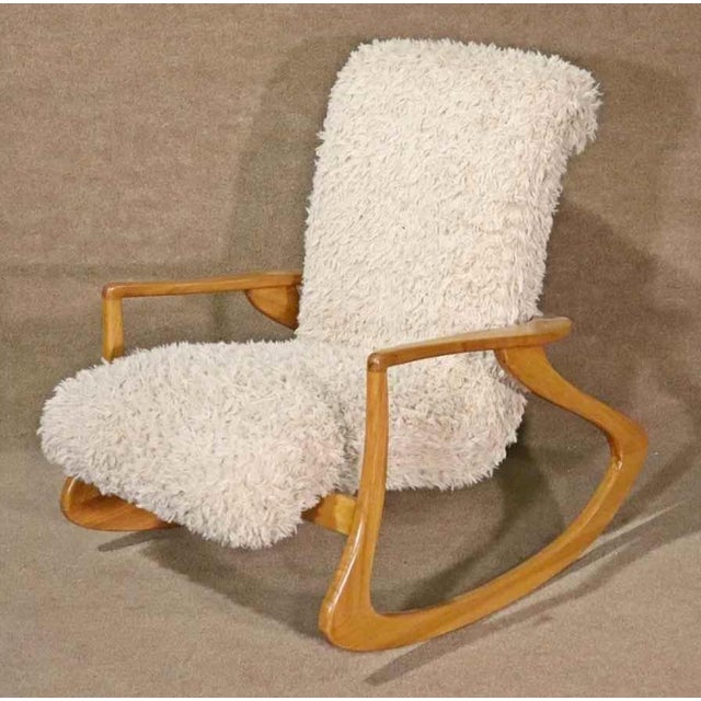 Mid-century modern style rocking chair in the design of Vladimir Kagan. Great form throughout the wrapping wood frame,...