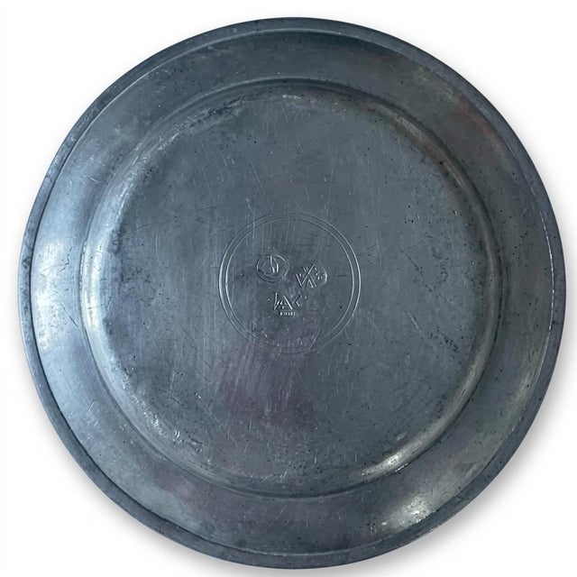 A beautifully marked antique Continental European pewter plate, notable for its substantial weight, finely molded reeded...