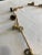 This vintage handcrafted brass bell garland features aged brass bells strung on a braided rope, creating a charming...
