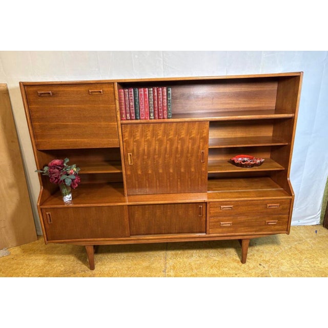 Danish-Style Mid Century Modern Teak Highboard by Elliotts of Newbury Circa 1960 A striking mid century modern teak...