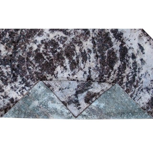 Beautiful Vintage Overdyed Rug with a gray field and black accents with an overall abstract design. This rug measure: 7′7″...