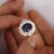 GIA certified 6.75 carat oval cut natural blue sapphire with a a baguette cut diamond halo in a ballerina style platinum...