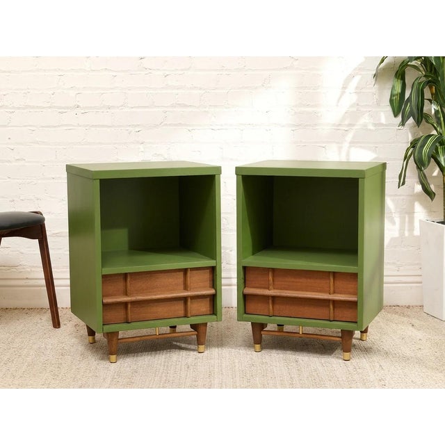 A distinctive pair of nightstands combining bold green finishes with warm natural wood accents. Each piece features a...