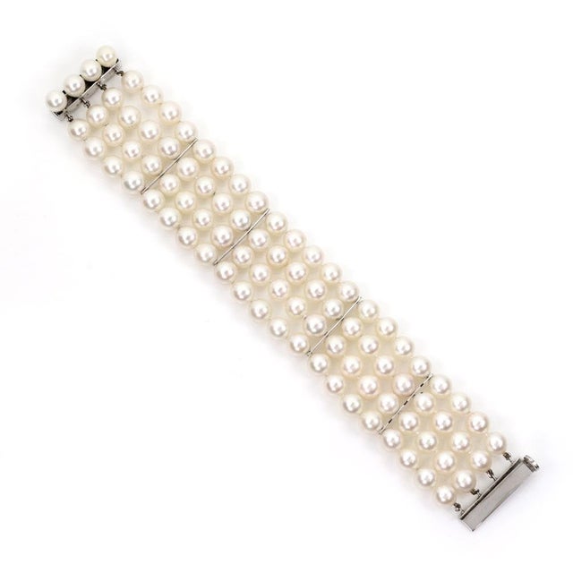 ​This lovely vintage bracelet is crafted from 14k white gold featuring 4 strands of lustrous pearls, they are divided in...