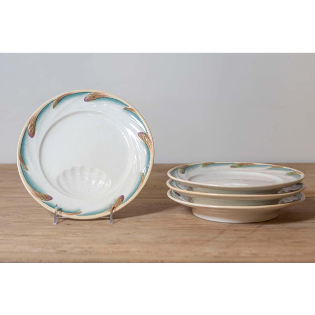 Four French Sarreguemines asparagus plates from the late 19th century, with teal accents and shell-shaped hole for the...