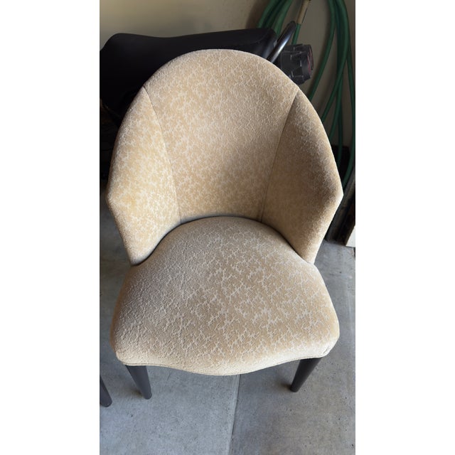 Pair of Donghia Shadow Arm Chairs upholstered in jacquard leaf print in camel tan color. Add a touch of elegance to your...
