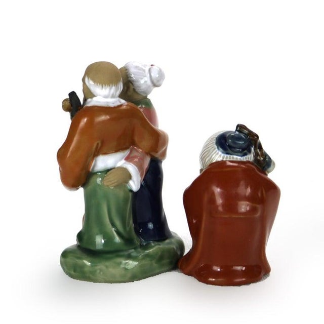 Two Japanese Pottery Figural Groups Signed 20thC. Measures- 5.25"H x 3.25"W x 2.5"D. A set of three intricately crafted...