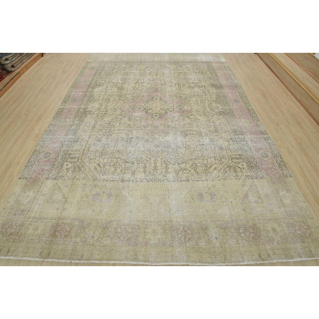 An authentic vintage traditional Tabriz rug hand-knotted with an all-wool pile on a cotton foundation. This oriental rug...