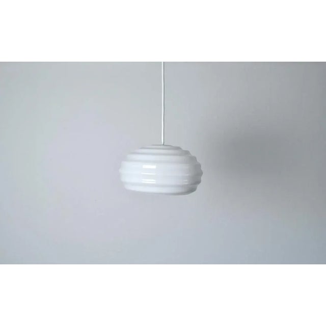 Mouth-blown opaline glass "new wave" pendant, designed in 1984 by verner panton for holmegaard. comes in original box....