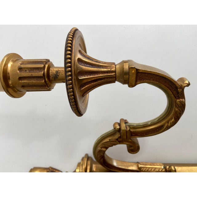 This pair of Louis the 16th style 3 arms wall lights are made of bronze. This is a French work by Maison Lucien Gau. Circa...