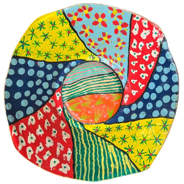 Handmade papier-mâché decorative bowl featuring a vibrant patchwork of florals, stripes, and graphic dot motifs in...
