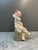 An elegant and expressive Lladro porcelain figurine depicting a contemplative jester on a textured pedestal. This...