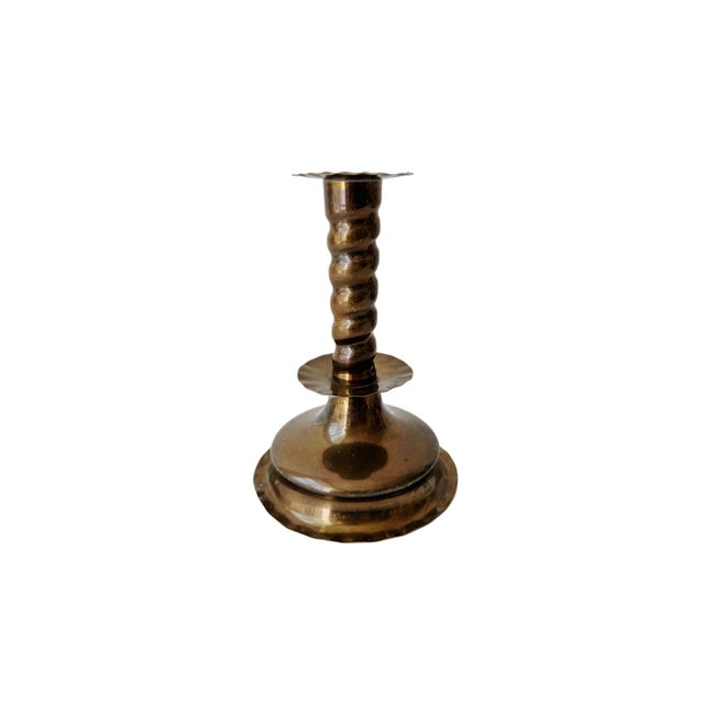 Elegant set of vintage brass candlesticks featuring a classic barley twist design with scalloped details. The warm aged...
