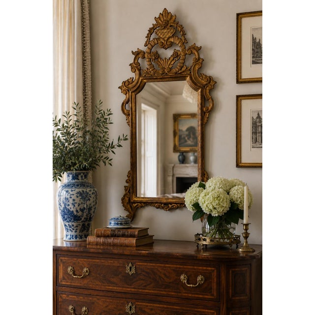 An exceptional late 19th century Italian giltwood mirror with richly carved Rococo detailing and a beautifully aged...