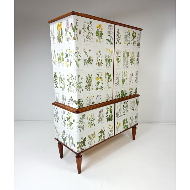 1950’s curved front Swedish Cabinet later papered with illustrations by C.A. Lindman book Nordens Flora. Cabinet consists...
