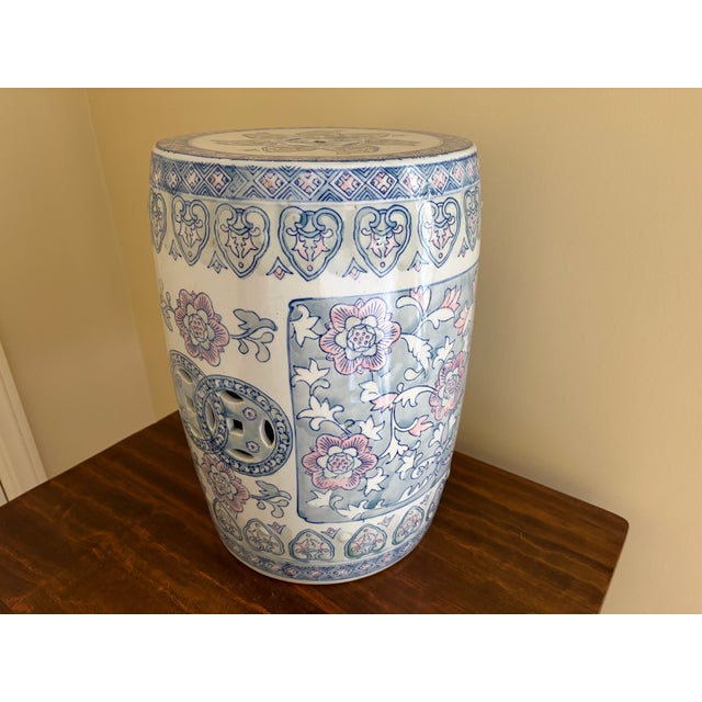 A classic Chinoiserie blue, white, pink, and green porcelain garden stool, plant stand, or small side table decorated with...