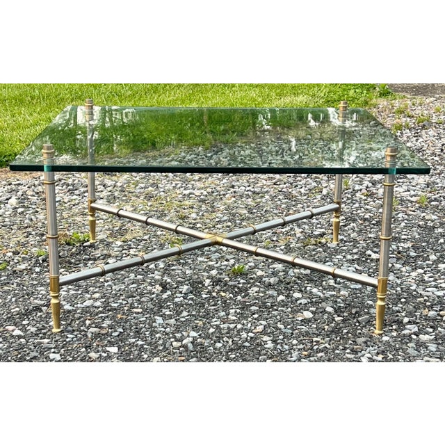High Quality Hollywood Regency style nickel and brass faux bamboo glass top coffee table. Bamboo inspired legs and cross...