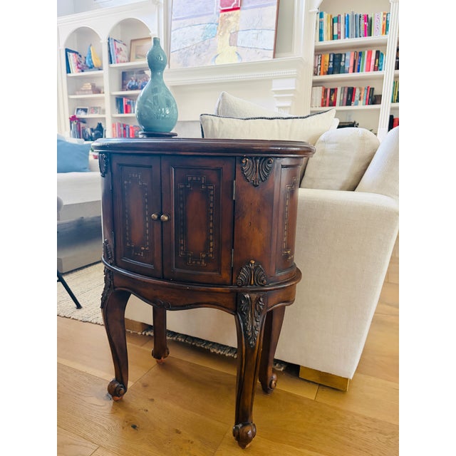 An elegant and increasingly difficult-to-find matching pair of Seven Seas accent cabinet tables by Hooker Furniture. Each...