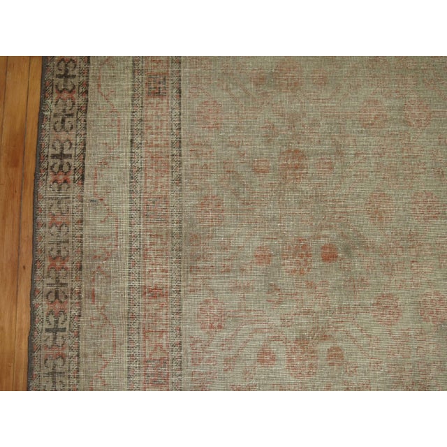 Faded Distressed Khotan rug in a gallery format, circa late 19th century, measures: 6'3" x 12'6" Khotan rugs were produced...