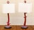 A pair of faux red coral table lamps. Each with a central coral branch rising from a textured rock work mound mounted on...
