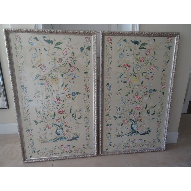 A Fabulous pair of chinoiserie paintings on silk with elaborate frames by Chelsea House. Makes a wonderful statement in a...