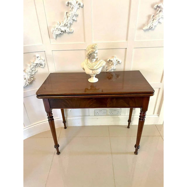 Antique George III quality mahogany fold over tea table having a quality mahogany fold over top opening to reveal a...