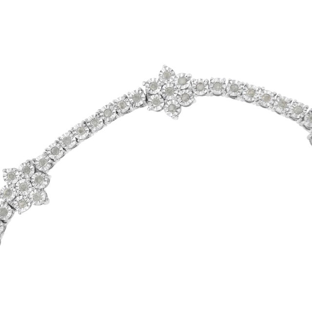 Elegant and timeless, this gorgeous sterling silver floral link bracelet features 1.0 carat total weight of round cut...
