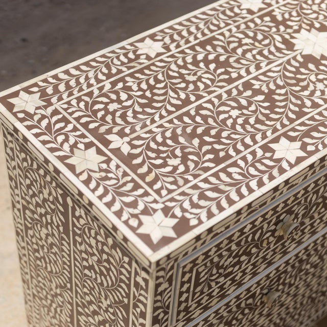 The Arabesque Bone Inlay Four-Drawer Chest combines traditional floral ornamentation with a structured, architectural...