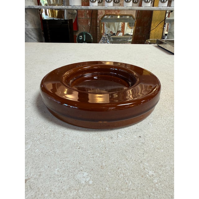 Striking vintage lidded box crafted in thick amber lucite, featuring a sculptural ring-form lid and a removable dark brown...