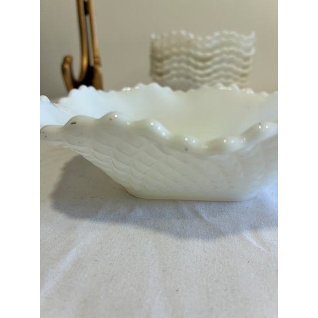 This charming set of 8 milk glass bowls showcases a pressed quilted diamond pattern with a soft, ruffled scalloped edge on...