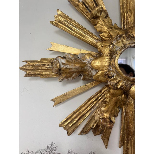 Contemporary Neo Baroque Style Giltwood Sunburst Mirror by artist L. Cook. Hand-carved, gesso, bole, water gilded and...