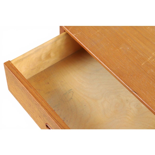 A compact and beautifully proportioned four-drawer teak chest, designed by Nils Jonsson in his iconic "Domi 4" model. A...