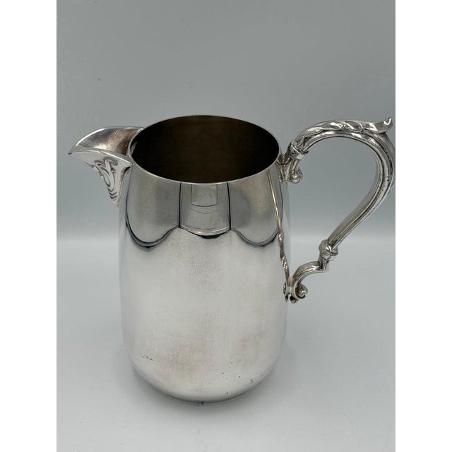 Elegant early 20th-century silver plate creamer jug made by Sheridan silver in Taunton. This piece is characterized by its...