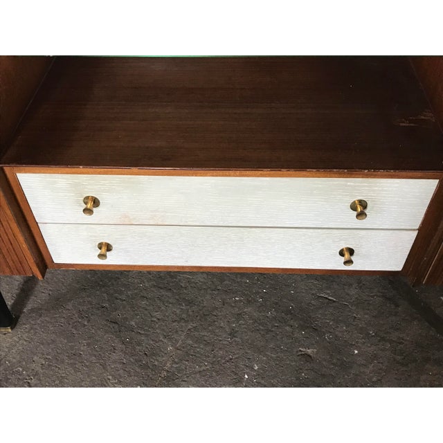 - The mid-century teak dressing table from the 1960s - With black shaped legs and original brass feet - Large mirror and a...