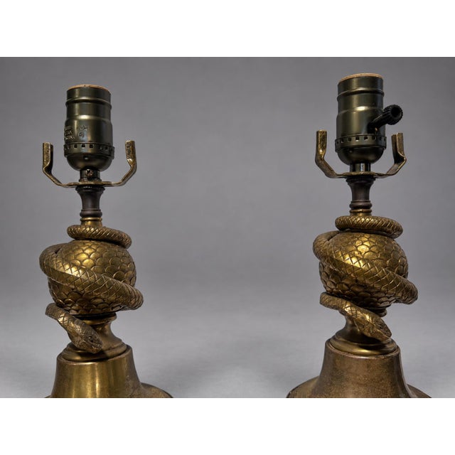Pair of decorative table lamps in the Continental Empire Revival taste, early 20th century, maker unidentified. Cast and...