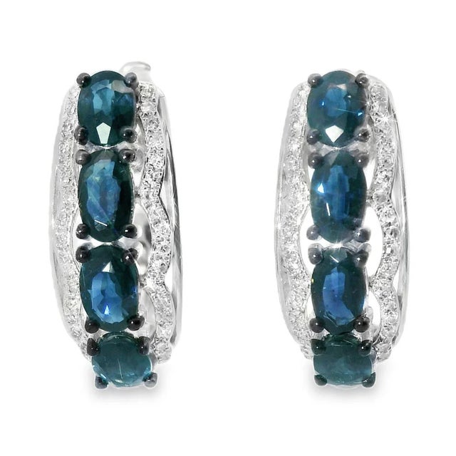 14K White Gold Sapphire & Diamond Huggie Earrings Elegant 14K white gold huggie earrings featuring 8 natural oval...