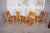 A beautifully crafted set of four solid pine dining chairs featuring traditional pegged joinery, carved leg accents, and...