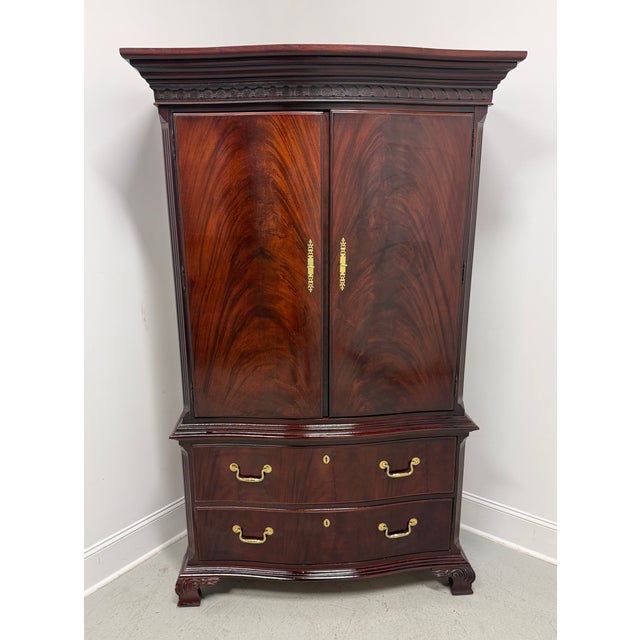 A Chippendale style armoire / linen press made by Thomasville, from their The Mahogany Collection. Mahogany with flame...