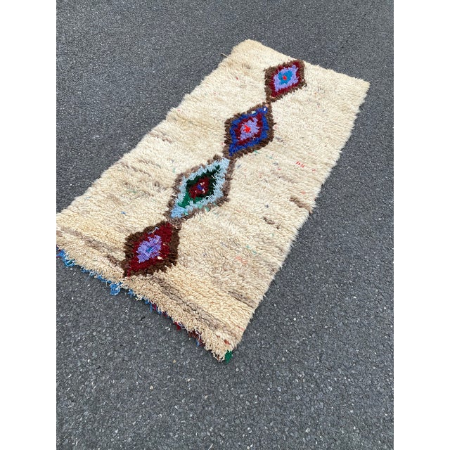 Hand-woven by the Berber women in the Atlas Mountains, this Vintage rug is created with soft natural wool fibers from the...