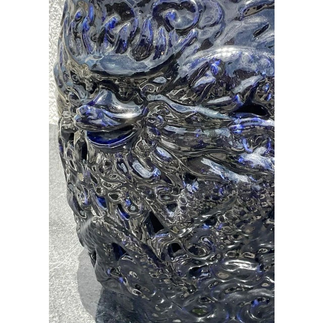 A fabulous pair of gorgeous glazed ceramic low stools. A brilliant inky blue with an incredible dragon motif. Perfect...