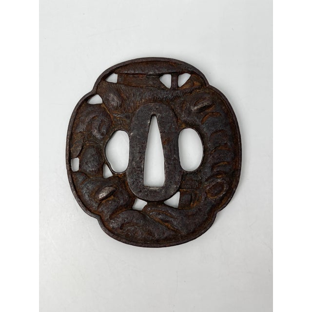 An authentic antique Japanese samurai sword hilt (tsuka) crafted from iron and beautifully engraved with traditional...